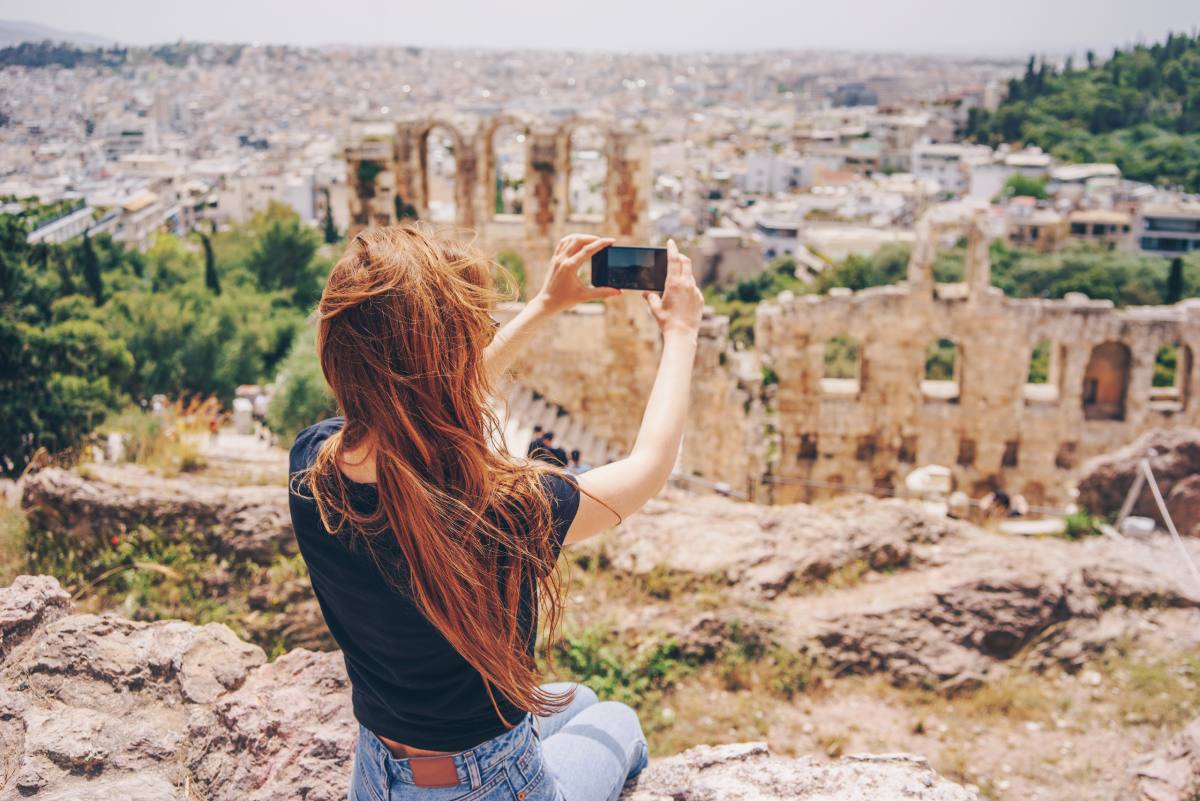 Woman photographing the Acropolis © iStock