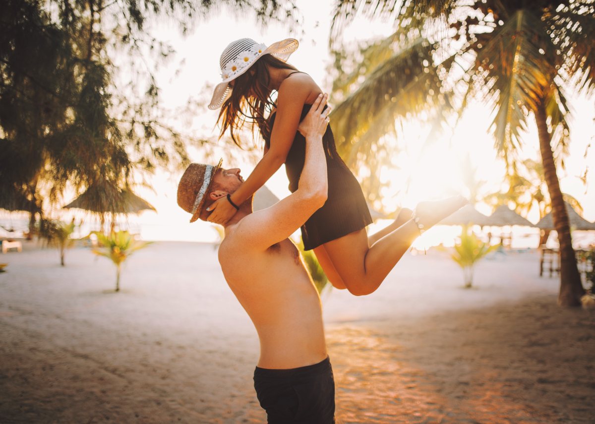 A couple on the beach enjoying exotic holidays © iStock